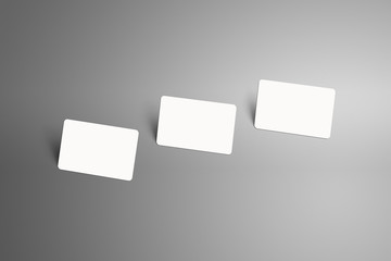 Realistic mockup of a three  bank (gift) card with shadows  on a gray background.
