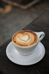 Cappuccino coffee cup on wood background