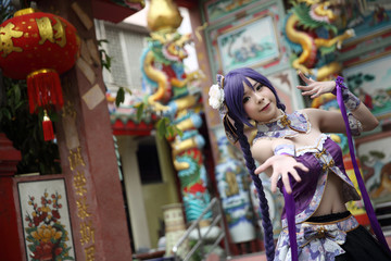 Fototapeta premium Portrait of asian young woman with purple Chinese dress cosplay with temple