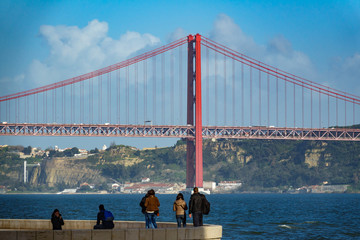 Long shot of 25 de Abril Bridge in Lisbon with tourists