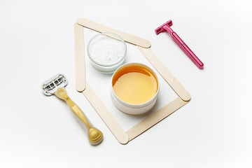 Tools for depilation on a white background, top view