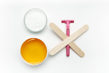 Tools for depilation on a white background, top view, flat lay