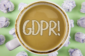 Handwriting text Gdpr Motivational Call. Concept meaning General Data Protection Regulation Information Safety written on Tea in white Cup within Crumpled Paper Balls on plain Green background.