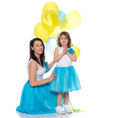 Mom and daughter with colorful balloons.