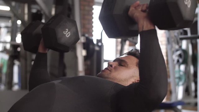 Athlete with dumbbell exercising