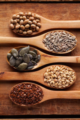 Grains, cereals and seed in wooden spoons. Oat, wheat, rye, secale, soya, Flax seed. Flat lay.