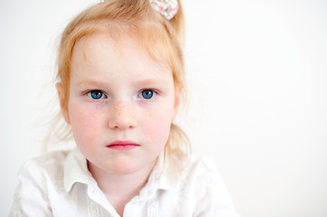 The girl attentively and seriously looks forward