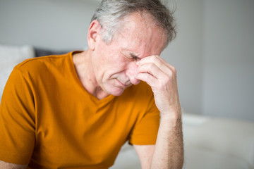 Senior man suffering from migraine