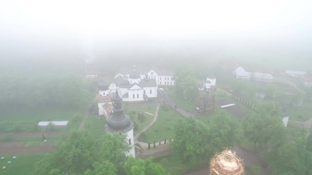 Cloudy day fog. Old monastery in the morning fog was shot by a dron