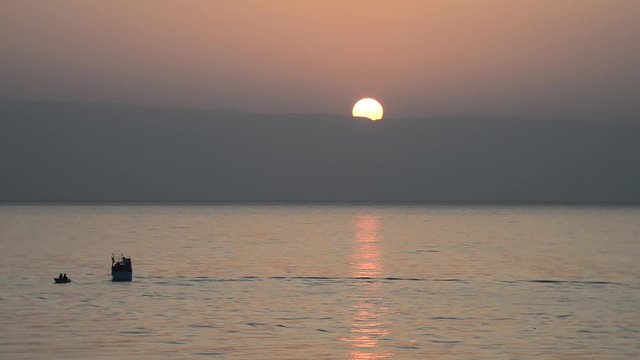 Prime luci del giorno con natanti e pescatori al lavoro