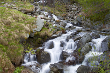 Small waterfall of a creek downhill to the Gran Paradiso National Park