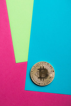 Overhead view of bitcoin on colorful background