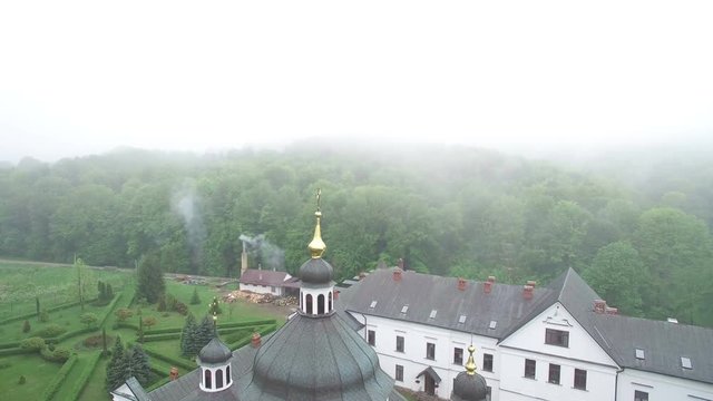Cloudy day fog. Old monastery in the morning fog was shot by a dron