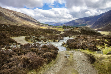 Scottish landscape and brook in Cairngorm Mountains. Way from Invermark to Mount Keen. Angus, Aberdeenshire, Scotland, United Kingdom.