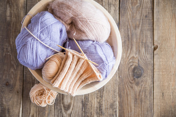 tangles with a knitting thread on a wooden table