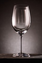 two empty wineglasses in row on black