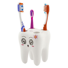 Toothbrush holder in form of tooth with cartoon face with three toothbrushes. One children and two...