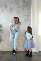 Fototapeta na wymiar lookbook. Mom and daughter in the same clothes