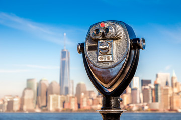 tourist binoculars at Liberty Island in front of Manhattan Skyline, New York City, USA
