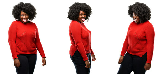 Young beautiful african plus size model sticking out tongue at camera at sign of disobedience,...