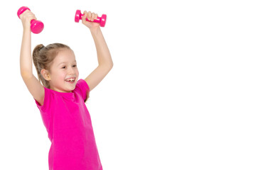 Little girl doing exercises with dumbbells.