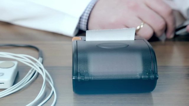 Doctor prints on the ECG ECG printer close-up