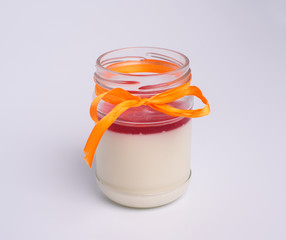 Close up photograph of a fancy panna cotta with strawberries