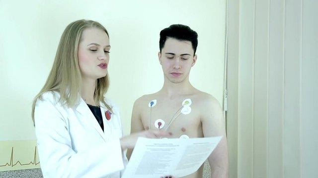 Installing sensors on the patient for heart examination. Monitor HOLTER. This apparatus is monitor heart activity during period