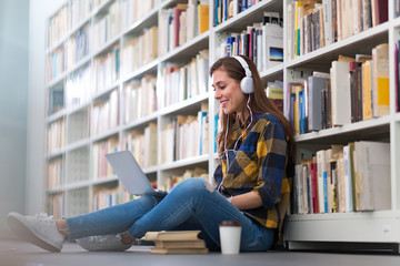 Young female student studying in the library
