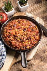 Chili con carne in a clay pan.