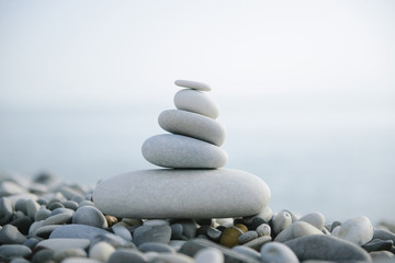 Close-up of a conical Stack of stones on a pebble beach