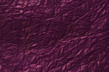 Dark burgundy textured paper background with glowing golden sparkles