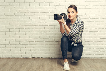 Pretty woman is a professional photographer with dslr camera