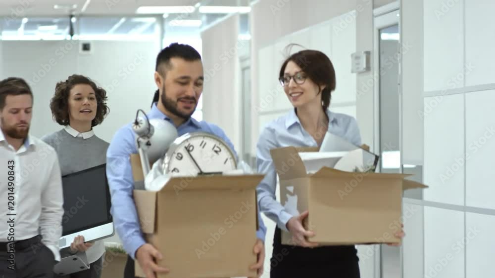 Aufkleber multi-ethnic team of office workers walking through hallway towards the camera while moving into new