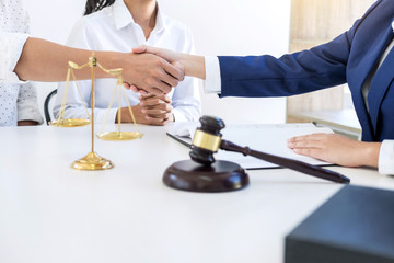 Handshake after good cooperation greeting, Having meeting with team at law firm, Consultation between a female lawyer and businessman customer, tax and the company of real estate concept