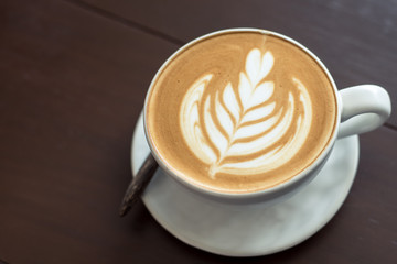 coffee cup latte art. Hot coffee cappuccino latte art. A Cup of hot latte art coffee on wooden table, 