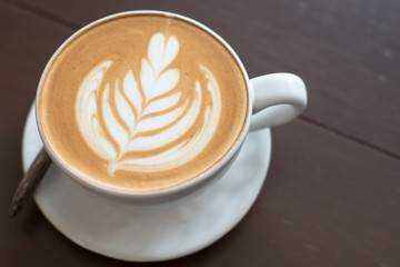 coffee cup latte art. Hot coffee cappuccino latte art. A Cup of hot latte art coffee on wooden table, 