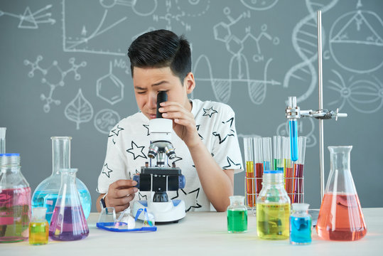 Handsome Pupil Using Microscope