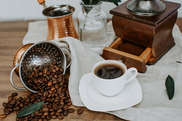 Coffee beens, copper old style hot coffee, decorated with olive brunch. Rural morning coffee