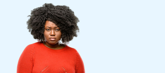 Beautiful african woman irritated and angry expressing negative emotion, annoyed with someone, blue...
