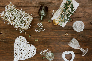 Gold vintage silverware, linen napkin and olive brunch. Trendy rustic table arrangement