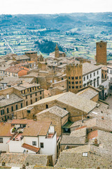 aerial view of buildings roofs and green hills in Orvieto, Rome suburb, Italy