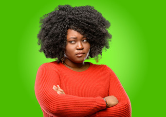 Beautiful african woman nervous and scared biting lips looking camera with impatient expression,...