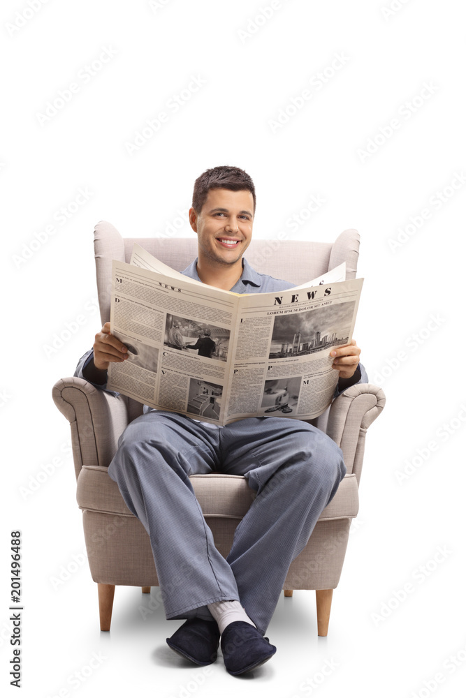 Sticker man in pajamas seated in an armchair holding a newspaper