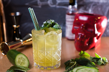 alcoholic cucumber cocktail in a glass cup on the table