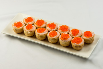 Tartlets with cheese and red caviar. Selective focus. Copy space