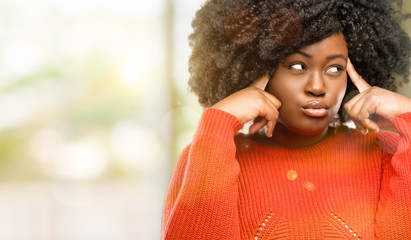 Beautiful african woman doubt expression, confuse and wonder concept, uncertain future, outdoor