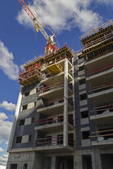 New residential building with hgh rise tower crane construction site .