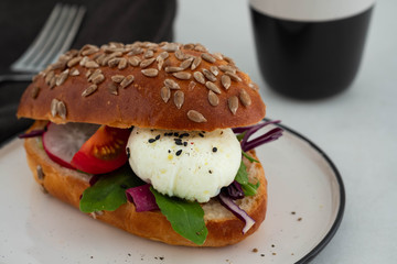 Fresh avocado breakfast with egg benedict sandwich. Green salad and seeds, healthy vegetarian food concept. Food background, copy space.