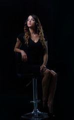 Obraz na płótnie Canvas Studio shoot of beauty woman posing on the chair